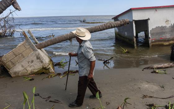 Antonio Mayoral, 76, walks past the place where his house once stood in El Bosque, Mexico, Nov. 7, 2022, amid rising sea levels that are destroying homes built on the shoreline and forcing villagers to relocate. (OSV News/Reuters/Gustavo Graf)