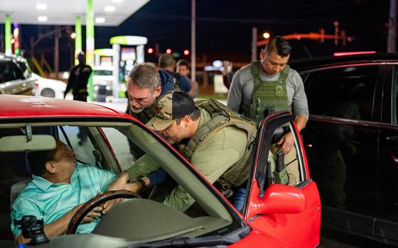 U.S. Immigration and Customs Enforcement officers detain a man from a car stopped by Tennessee Highway Patrol at a gas station in South Nashville, as he could not produce any alternative identification proof other than his expired driving license, during an operation conducted by ICE along with THP to detain noncitizens across the city of Nashville, Tennessee, on May 10, 2025. (OSV News/Reuters/Seth Herald)