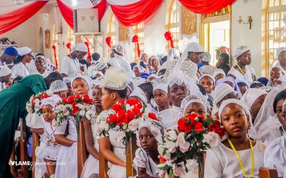 Auxiliary Bishop Ernest Obodo of Enugu, in the southeastern part of Nigeria, confers the sacrament of confirmation on 983 people at the Holy Spirit Cathedral on June 4, 2025. The ceremony included both children and adults, but youth made up the majority. Faith grows in Nigeria amid extreme persecution. Pope Leo prayed for Christians massacred in the country over the June 14-15 weekend. (OSV News photo/courtesy Diocese of Enugu)
