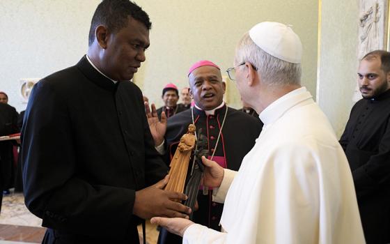 Pope Leo XIV receives a gift during a meeting with bishops from Madagascar visiting Rome for the Holy Year 2025 at the Vatican June 16, 2025. (CNS/Vatican Media)