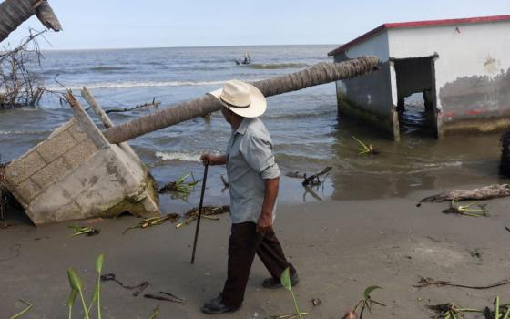 A man walks past the place where his house once stood in El Bosque, Mexico, Nov. 7, 2022, amid rising sea levels that are destroying homes built on the shoreline and forcing villagers to relocate. (OSV News/Reuters/Gustavo Graf)