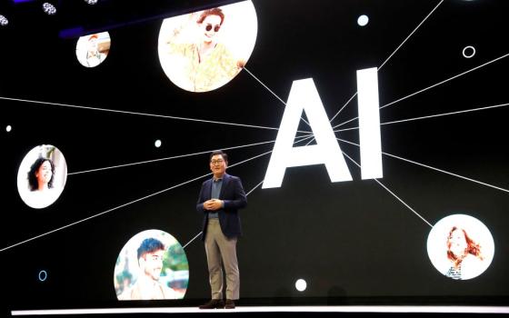 Man on stage w AI images behind him