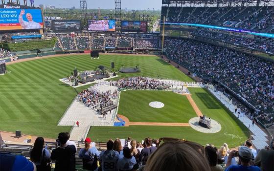 Thousands of people attend a Mass celebrating Pope Leo XIV at Rate Field, home of the Chicago White Sox, June 14 in Chicago. Pope Leo, a Chicago native, spoke in a prerecorded video. (RNS photo/Rachel Berkebile)