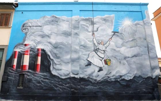 Pope Francis cleans the sky of pollution in graffiti by the artist Maupal, inspired by "Laudato Si'." (AP/Andrew Medichini)