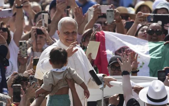 Pope Leo XIV waves as he arrives for his weekly general audience in St. Peter's Square at The Vatican, Wednesday, June 11, 2025. (AP Photo/Andrew Medichini)