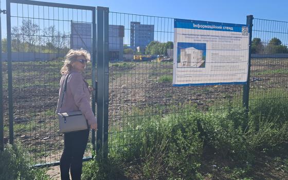 St. Don Bosco School principal Vitalia Vovk at the entrance to the construction site of the new school in Zaporizhzhia, a city in southern Ukraine (sign obscured for safety reasons). (Marc Roscoe Loustau)