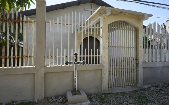 In front of a small Catholic church in the Fabio Ochoa neighborhood of Tocoa, Honduras, a cross marks the spot where Juan López, a Catholic delegate of the word, was assassinated on Sept. 14, 2024. López had just finished leading a celebration of the word in the church. (NCR photo/Paul Jeffrey)