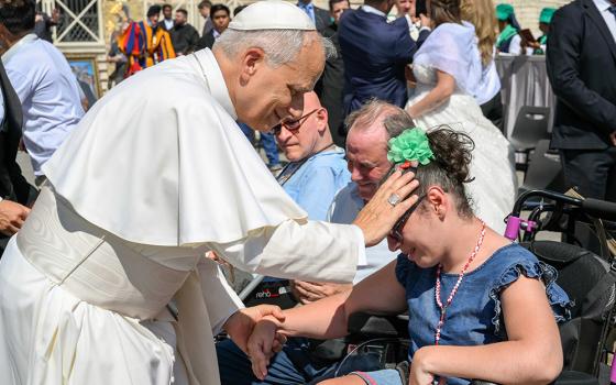 Pope Leo XIV blesses a young woman in St. Peter's Square at the Vatican before his weekly general audience June 25, 2025. (CNS/Vatican Media)