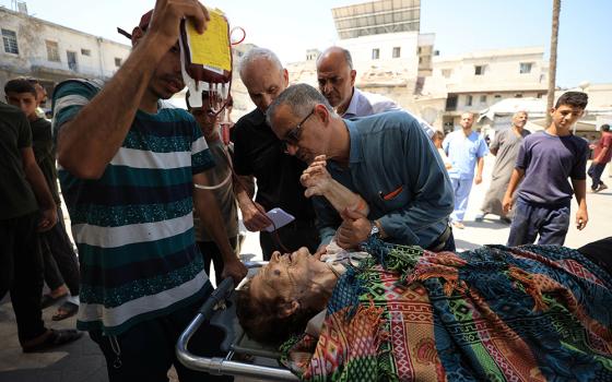 A wounded Palestinian Christian woman is brought into Al-Ahli Arab Baptist Hospital following what initial reports and medics say was an Israeli tank attack on the church on the Holy Family Parish — the only Catholic parish in the Gaza Strip, in Gaza City July 17, 2025. (OSV News/Reuters/Dawoud Abu Alkas)