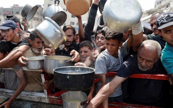 Palestinians gather to receive food from a charity kitchen amid a hunger crisis in the central Gaza Strip July 29, 2025. (OSV News photo/Hatem Khaled/Reuters)