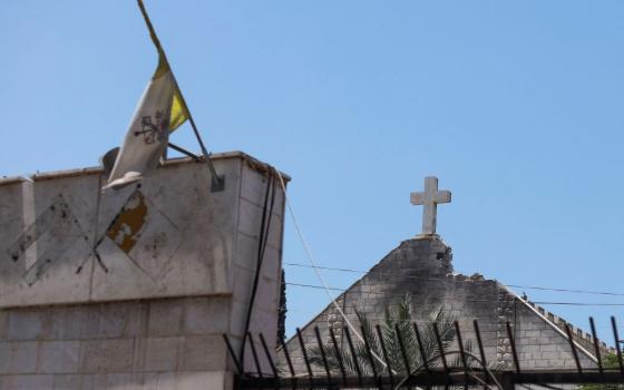 The Vatican City flag flies July 18 at Holy Family Church in Gaza City which was hit in an Israeli strike July 17, killing three and injuring 10. Holy Family is the only Catholic church in Gaza City, and it has sheltered Muslims and Christians during the war. (OSV News/Reuters/Khamis Al-Rifi)