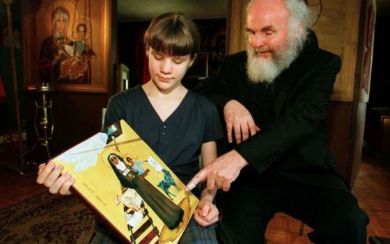Benedicta McCarthy and her father, Melkite Fr. Emmanuel Charles McCarthy, from Brockton, Mass., display an icon of her namesake Sr. Teresa Benedicta, also known as Blessed Edith Stein in a 1997 photo. (CNS/Reuters)