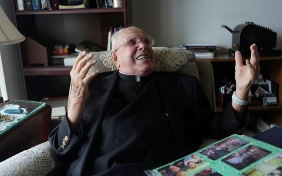 Fr. James Kelly laughs during an interview at his apartment in the Normandy Farms Estates retirement community in Blue Bell, Pa., on June 18. (AP/Luis Andres Henao)