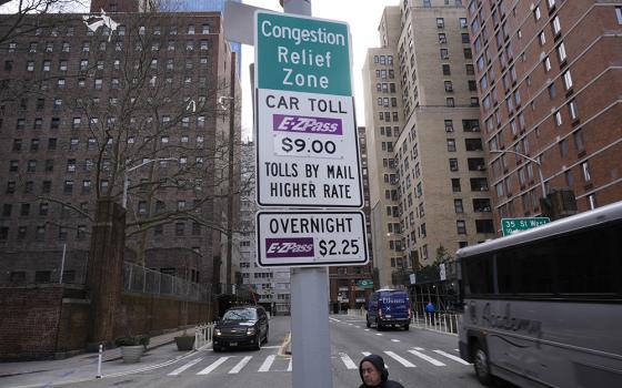 Signs advising drivers of congestion pricing tolls are displayed near the exit of the Lincoln Tunnel in New York on Feb. 19, 2025. (AP photo/Seth Wenig)