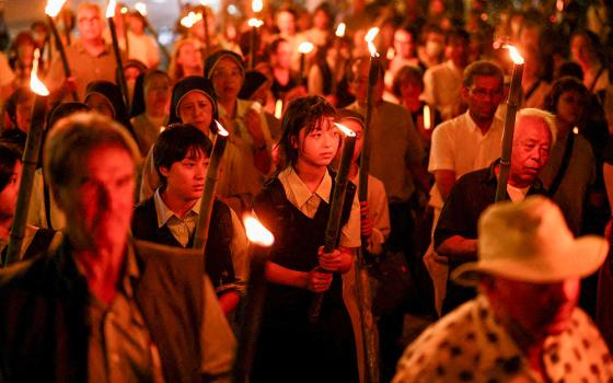 After a Peace Memorial Mass at Urakami Cathedral in Nagasaki, Japan, Aug. 9, 2025, people carry torches during a peace march to Hypocenter Park in commemoration of the 80th anniversary of the U.S. atomic bombing of Nagasaki. (OSV News/Reuters/Issei Kato)