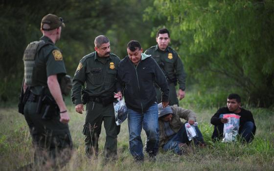  U.S. Border Patrol agents apprehend migrants in Mission, Texas, April 9, 2019, after they illegally crossed the U.S.-Mexico border, in this file photo. (OSV News photo/Loren Elliott, Reuters)