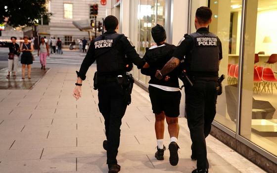 Members of the D.C. Metropolitan Police detain a person after an altercation between members of the public in Washington Aug. 14, 2025, following President Donald Trump's announcement of the federal takeover of the Metropolitan Police Department under the Home Rule Act and the deployment of the National Guard to assist in crime prevention in the nation's capital. (OSV News/Reuters/Nathan Howard)