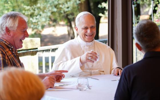 Pope Leo XIV shares a laugh with guests assisted by the Albano diocesan Caritas agency during a luncheon at the Borgo Laudato Si’ in Castel Gandolfo, Italy, Aug. 17, 2025. (CNS photo/Lola Gomez)