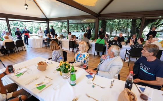 Pope Leo XIV speaks to guests assisted by the Albano diocesan Caritas agency during a luncheon at the Borgo Laudato Si’ in Castel Gandolfo, Italy, Aug. 17, 2025. The luncheon with the pope followed a Mass the pope celebrated in nearby Albano Laziale. (CNS/Lola Gomez)