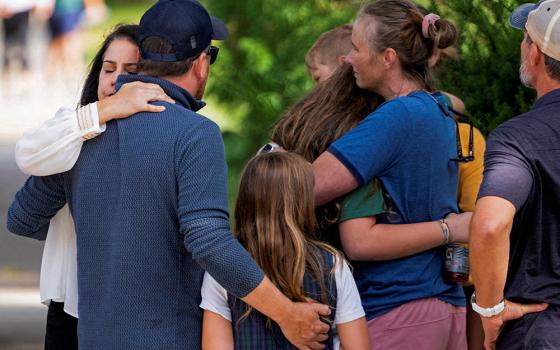 Families and loved ones reunite following a shooting at Annunciation Catholic School in Minneapolis Aug. 27, 2025. A shooter opened fire with a rifle through the windows of the school's church and struck children celebrating Mass during the first week of school, killing two and wounding 17 people in an act of violence the police chief called "absolutely incomprehensible." (OSV News/Reuters/Ben Brewer)