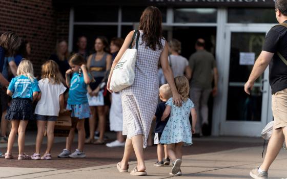 Parishioners arrive for the first Mass at Annunciation Church in Minneapolis Aug. 30, 2025, which is home to an elementary school and was the scene of a shooting. The shooter opened fire with a rifle through the windows of the school's church and struck children attending Mass Aug. 27 during the first week of school, killing two and wounding 18 others. (OSV News photo/Tim Evans, Reuters)
