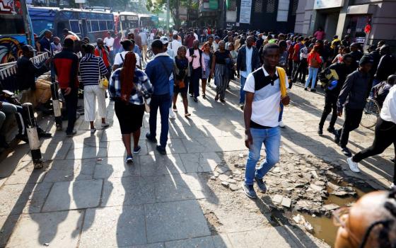 Pedestrians walk on street in Nairobi.