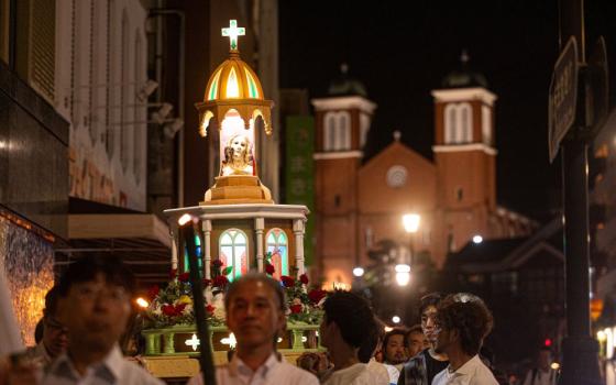 After a Peace Memorial Mass at Urakami Cathedral in Nagasaki, Japan, on Aug. 9, 2025, the 80th anniversary of the U.S. atomic bombing of that city, people participate in a torchlit procession to Nagasaki Peace Park. Urakami Cathedral was rebuilt and dedicated in 1959 on the site of the original cathedral destroyed in the bombing on Aug. 9, 1945. (OSV News/Mihoko Owada, Catholic Standard)