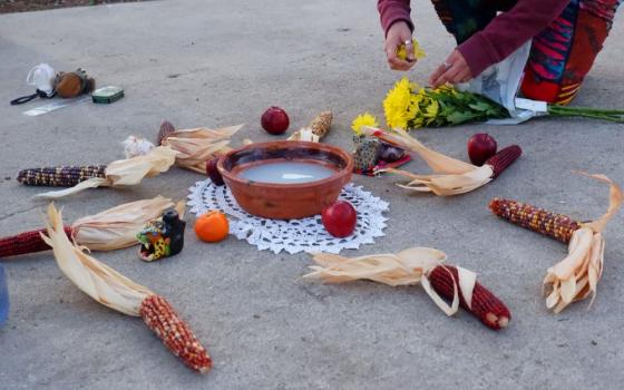 A community member prepares a temporary altar at the ceremony site in Brackenridge Park in San Antonio in February 2025. (RNS/Patrick Davis)