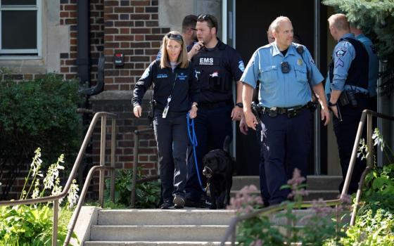 Law enforcement officers gather outside the Annunciation Catholic School as they respond to a mass shooting Aug. 27 in Minneapolis.