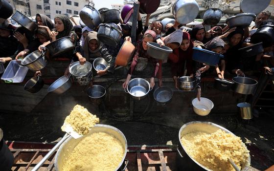 Palestinians wait to receive food from a charity kitchen in the Gaza Strip's Gaza City Aug. 15, 2025. (OSV News/Reuters/Dawoud Abu Alkas) 