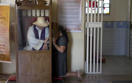 A priest listens to a pilgrim’s confession at Our Lady of Perpetual Help Church in Juazeiro do Norte, Brazil, on Oct. 30, 2015. (The Conversation/AP/Leo Correa)