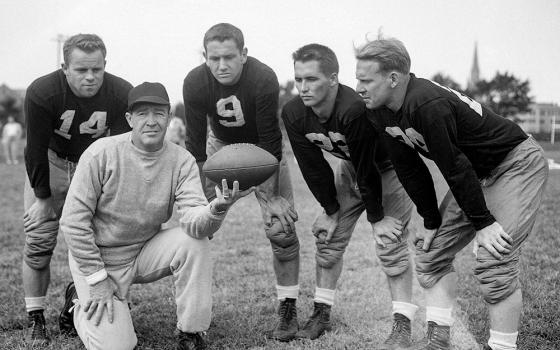 University of Notre Dame coach Frank Leahy, foreground, poses for a photo with four players at football practice on Aug. 31, 1949, in South Bend, Ind. (AP/Harry L. Hall, File)