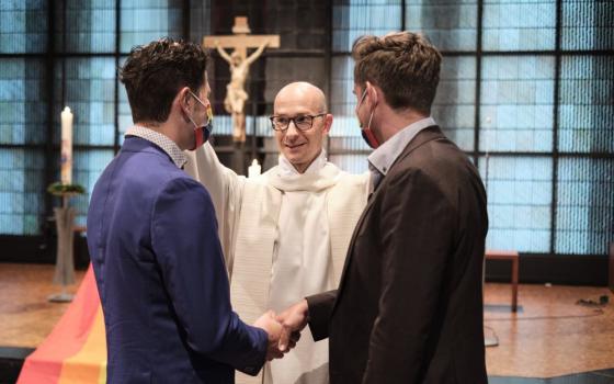 Fr. Christian Olding blesses a gay couple during a service called "Love Wins" in the Church of St. Martin in Geldern, Germany May 6, 2021. (OSV News/Rudolf Wichert, KNA)