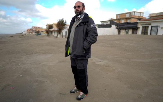 Fr. Andrea Conocchia stands on the beach of Torvaianica, Italy, Nov. 16, 2023. As part of his ministry to the LGBTQ community, Conocchia coordinated visits between transgender people and Pope Francis. (AP/Andrew Medichini)