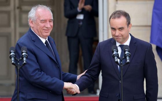Newly appointed French Prime Minister Sébastien Lecornu, right, shakes hands with outgoing Prime Minister Francois Bayrou at the end of the handover ceremony at Hotel Matignon in Paris Sept. 10. Lecornu resigned Oct. 6. (OSV News/Ludovic Marin, pool via Reuters)