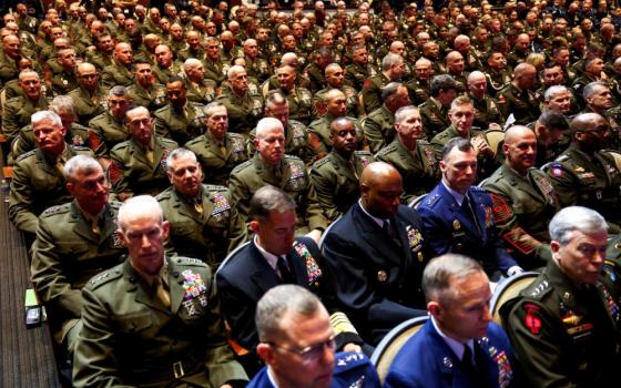 Members of the military wait for the U.S. President Donald Trump speech, as they attend a meeting convened by U.S. Defense Secretary Pete Hegseth, at Marine Corps Base Quantico in Virginia Sept. 30, 2025. In an unprecedented gathering, almost 800 generals, admirals and their senior enlisted leaders were ordered into one location from around the world on short notice. (OSV News/Reuters/Kevin Lamarque)