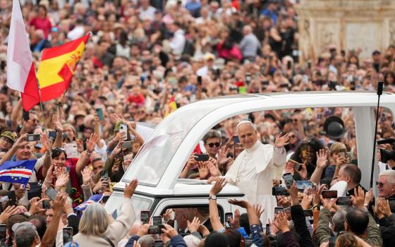 Pope Leo XIV greets people from the popemobile as he rides around St. Peter’s Square following Mass for the Jubilee of Migrants and the Jubilee of the Missions in St. Peter’s Square at the Vatican Oct. 5, 2025. (CNS photo/Lola Gomez)