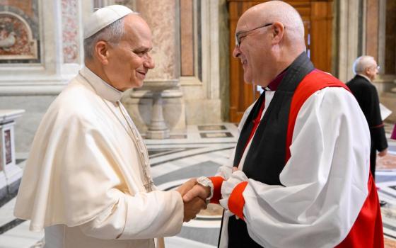 Pope Leo XIV greets Anglican Archbishop Stephen Cottrell of York before a Mass in St. Peter’s Square at the Vatican Nov. 1, and the proclamation of St. John Henry Newman, who ministered as Anglican before becoming Catholic, as a doctor of the church. (CNS/Vatican Media)