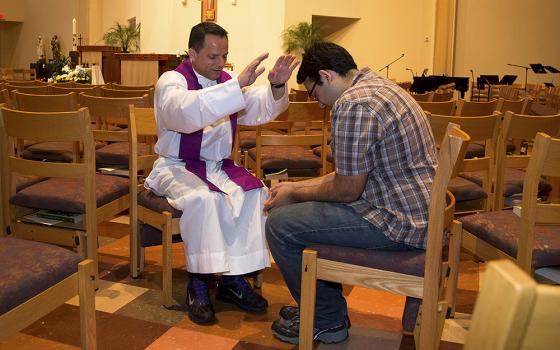 In this 2015 file photo, a priest blesses a student involved with the Fellowship of Catholic University Students at a church on the campus of the University of Texas at Austin at the University Catholic Center. (CNS/courtesy FOCUS)
