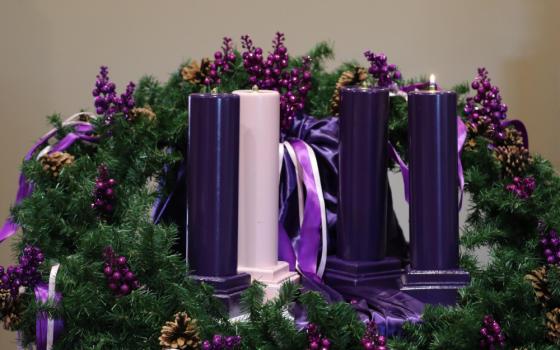 One purple candle is lit on an Advent wreath, the central symbolic rite of spiritual preparation for Christmas. Purple is the color of penitence and humility. The rose colored candle, lit the Third Week of Advent, represents a hopeful look toward Christ's coming. (OSV News/Bob Roller)