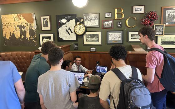Students at Benedictine College in Atchison, Kansas, watch the announcement of a new pope at a coffee shop May 8. Chicago-born Cardinal Robert Francis Prevost was elected as the next pope and he chose the papal name Leo XIV. (OSV News/Jack Figge)
