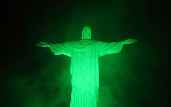 The statue of Christ the Redeemer is lit up in green on World Environment Day in Rio de Janeiro, June 5, 2025. Brazil is playing host to the COP30 United Nations climate change conference Nov. 10-21 in Belém. (OSV News/Reuters/Pilar Olivares)