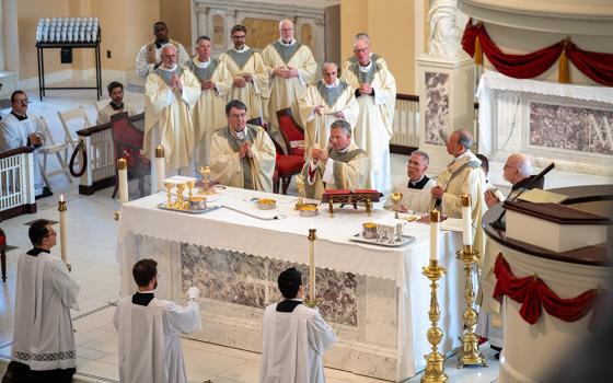 Standing at the altar from left, Cardinal Christophe Pierre, apostolic nuncio to the United States; Archbishop Timothy Broglio of the U.S. Archdiocese for the Military Services; and Baltimore Archbishop William Lori concelebrate Mass at the Basilica of the National Shrine of the Assumption of the Blessed Virgin Mary in Baltimore Nov. 10, 2025, to open the fall plenary assembly of the U.S. Conference of Catholic Bishops. (OSV News/Catholic Review/Kevin J. Parks)