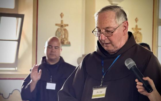 Franciscan Fr. Ed McKenzie leads a ritual during the Veterans Retreat at Mission San Luis Rey in Oceanside, California. In the background is Fanciscan Fr. Roger Lopez. (Jen Jauregui)