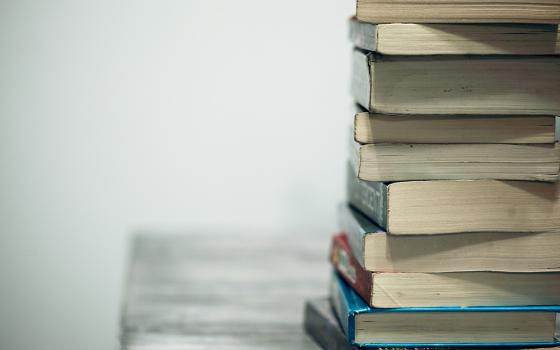 A pile of books (Unsplash/Alexander Grey)