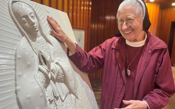 Sr. María Celina Mota Campos moves toward a sculpture for the blind at the Basilica of Our Lady of Guadalupe in Mexico City Nov. 6.