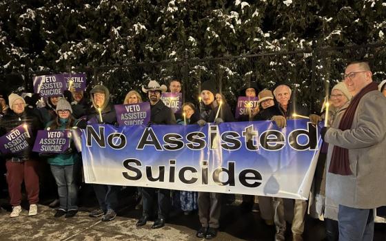 Opponents of New York state's proposed assisted suicide bill stand outside the governor's mansion in Albany, Dec. 3 for a candlelight vigil urging for Gov. Kathy Hochul to veto the bill passed by the Legislature. 