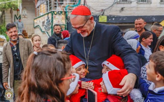 Cardinal Pierbattista Pizzaballa, Latin patriarch of Jerusalem, greets children as he visits the compound of Gaza City's Holy Family Parish during his Christmas pastoral visit Dec. 19. Holy Family is the only Catholic church in Gaza City, and it has sheltered Muslims and Christians since the Israel-Hamas war began in October 2023. (OSV News/Courtesy Latin Patriarchate of Jerusalem)