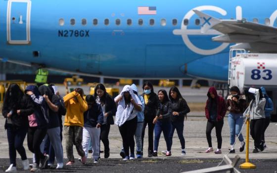 Guatemalan migrants arrive at La Aurora Air Base on a deportation flight from the United States, in Guatemala City, Feb. 18. (OSV News/Reuters/Cristina Chiquin)