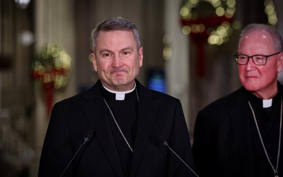 Archbishop Ronald A. Hicks, flanked by New York Cardinal Timothy M. Dolan, pauses while speaking during a news conference at St. Patrick's Cathedral in New York City Dec. 18, 2025, after Pope Leo XIV accepted the resignation of Dolan, and appointed Hicks as his successor. Archbishop Hicks was previously the bishop of Joliet, Illinois. (OSV News/Reuters/Brendan McDermid)